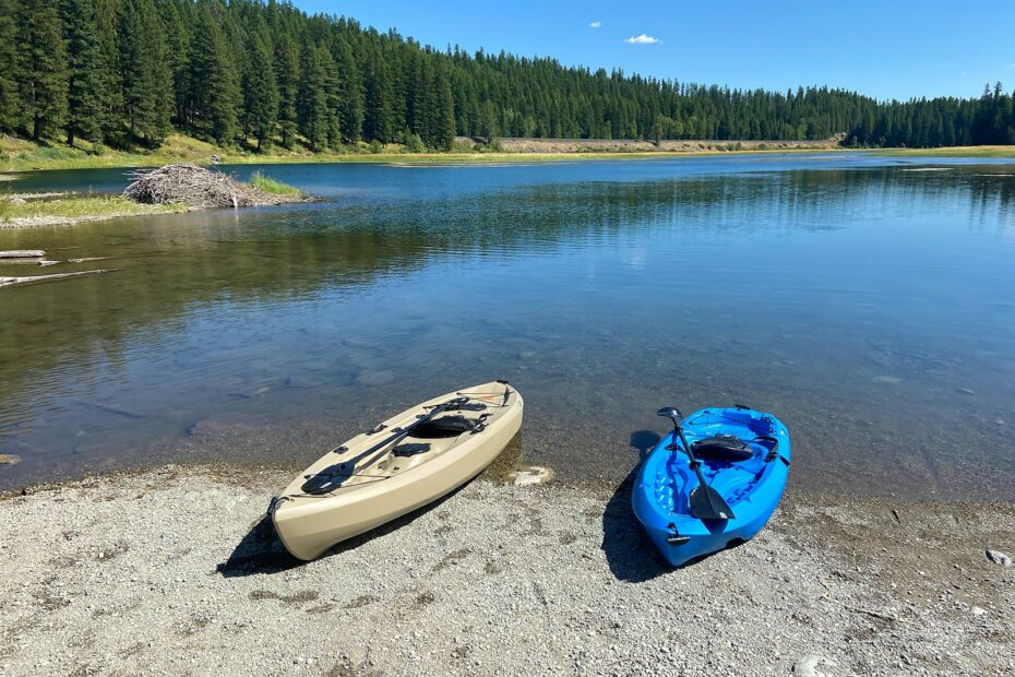 blue and white kayak on lake during daytime